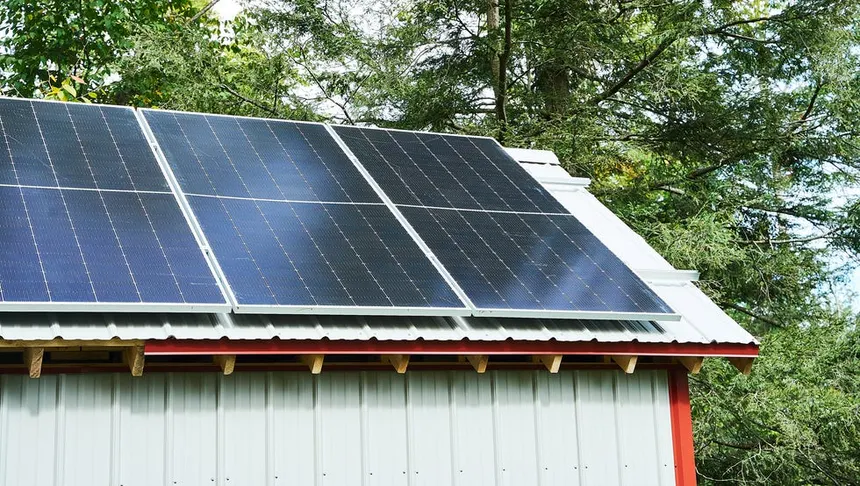 Solar panels installed on a remote metal-roof building surrounded by Algoma forest